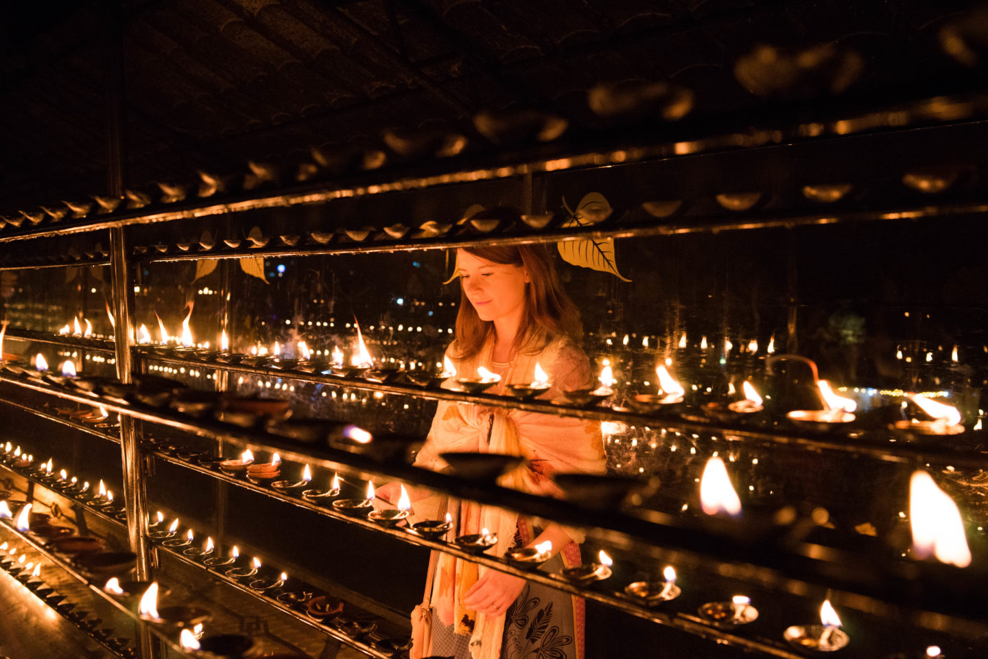 Kandy, Sri Lanka. Lighting Candles at the Temple of the Tooth.